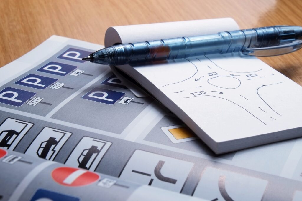 Traffic rules boo open with a paper and pen for note taking.